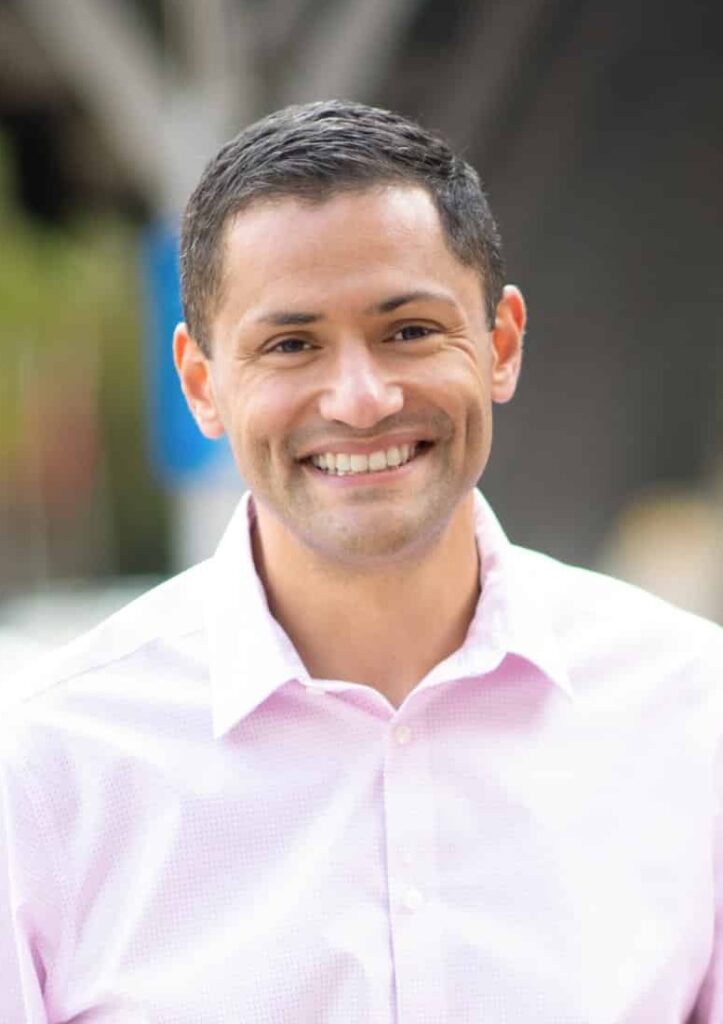 Rasoul_pink-shirt-uncropped-headshot-1020_1334-1-scaled